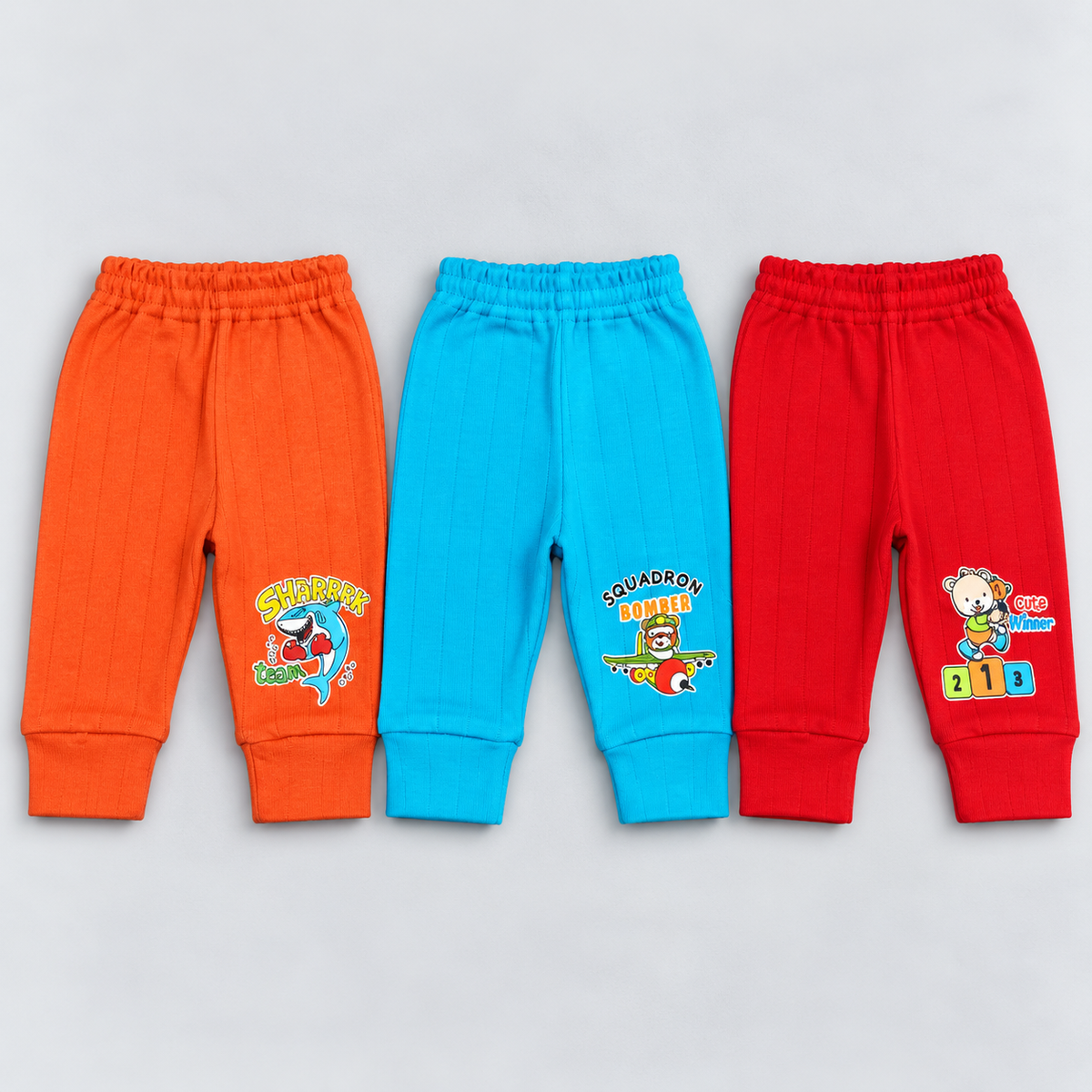 Cucumber baby boys pants set of 3 in orange, turquoise blue and red with colorful cartoon prints, elastic waistbands and ribbed ankle cuffs