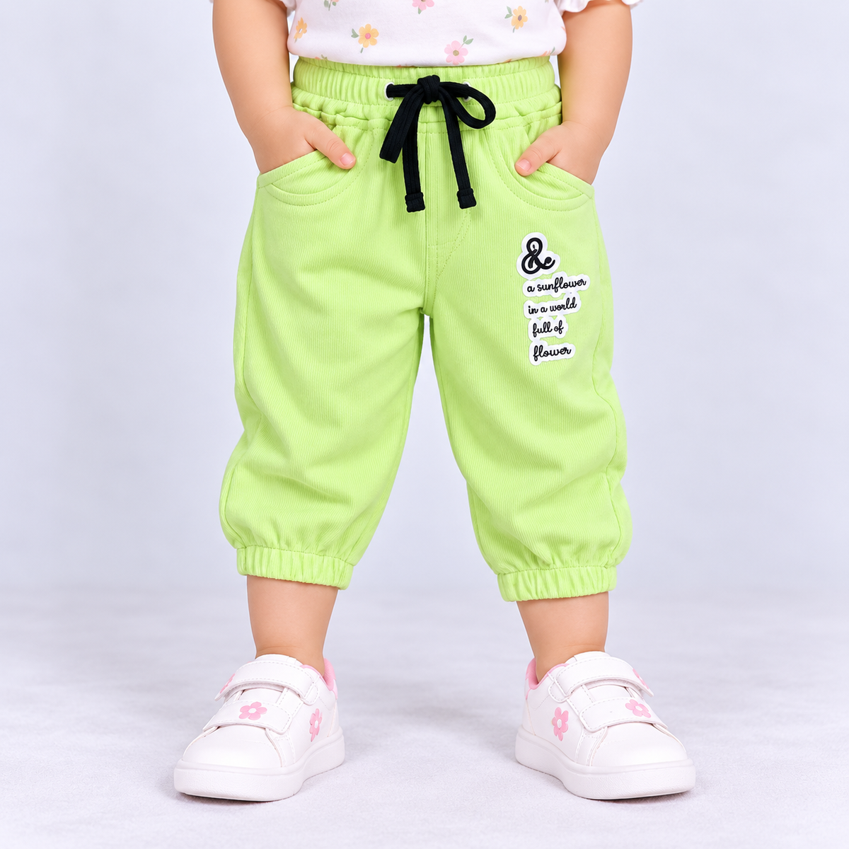 OlioKids green jogger pants with elastic waist, drawstring, side pockets and flower graphic print