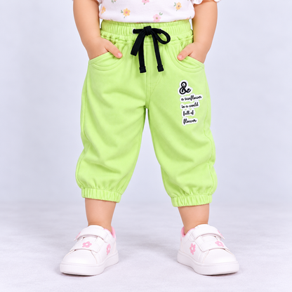 OlioKids green jogger pants with elastic waist, drawstring, side pockets and flower graphic print