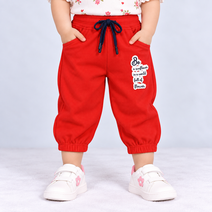 OlioKids red jogger pants with elastic waist, drawstring, side pockets and printed graphic detail