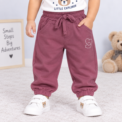 OlioKids girls pink jogger pants with elastic waist, drawstring, side pockets and heart graphic detail | Cutypi