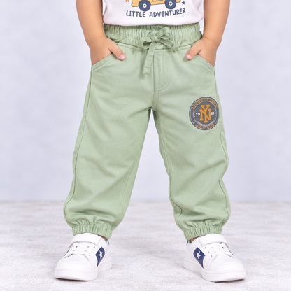 OlioKids boys green jogger pants with elastic waist, drawstring, side pockets and printed logo detail | Cutypi