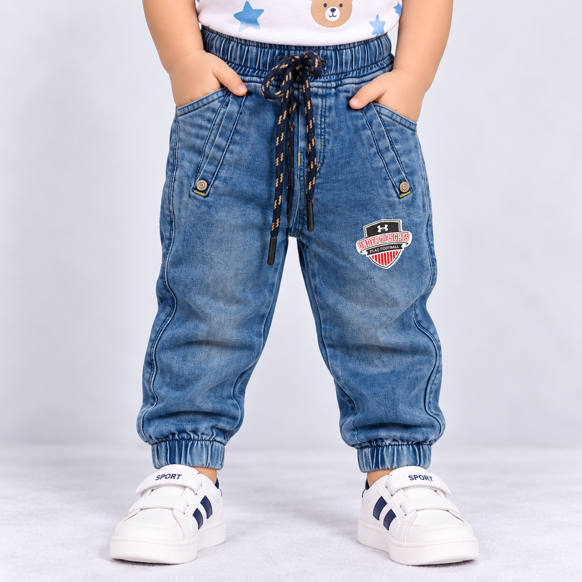OlioKids boys blue denim jogger pants with elastic waist, drawstring, front pockets and football graphic detail
