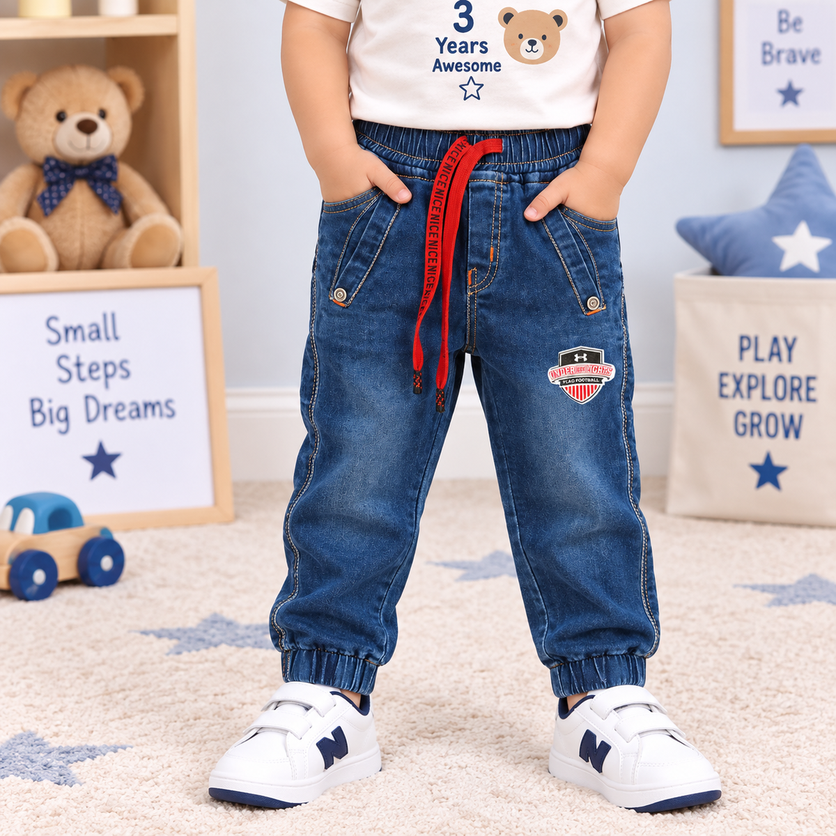 OlioKids boys blue denim jogger pants with elastic waist, red drawstring, pockets and football graphic print | Cutypi