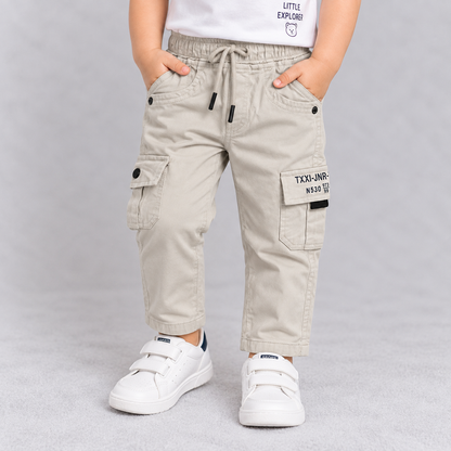 Taxi Junior boys off-white cargo pants with elastic waist, drawstring and utility pockets | Cutypi