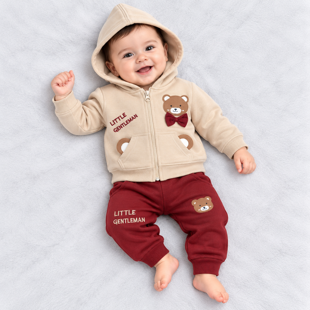 Krunchy baby boys cream hooded zip-up winter jacket with teddy bear appliqué and bow detail, paired with maroon jogger pants featuring matching teddy bear accents
