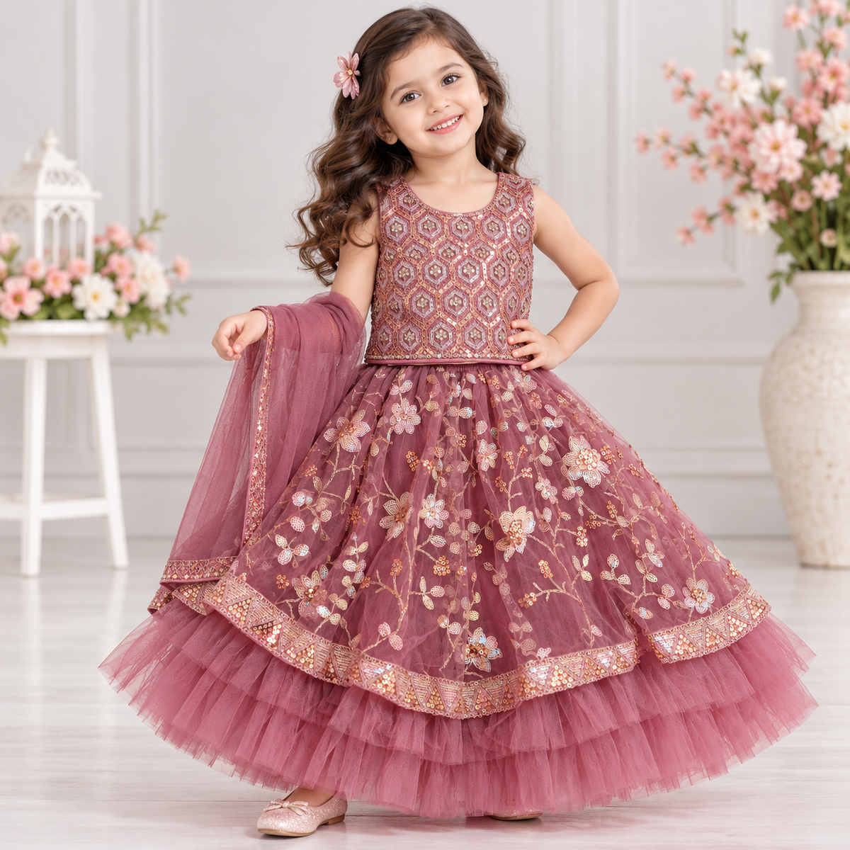 Cutypi girls dusty rose lehenga choli with sleeveless geometric embroidered blouse, floral sequin embellished flared skirt, layered net ruffles and matching dupatta